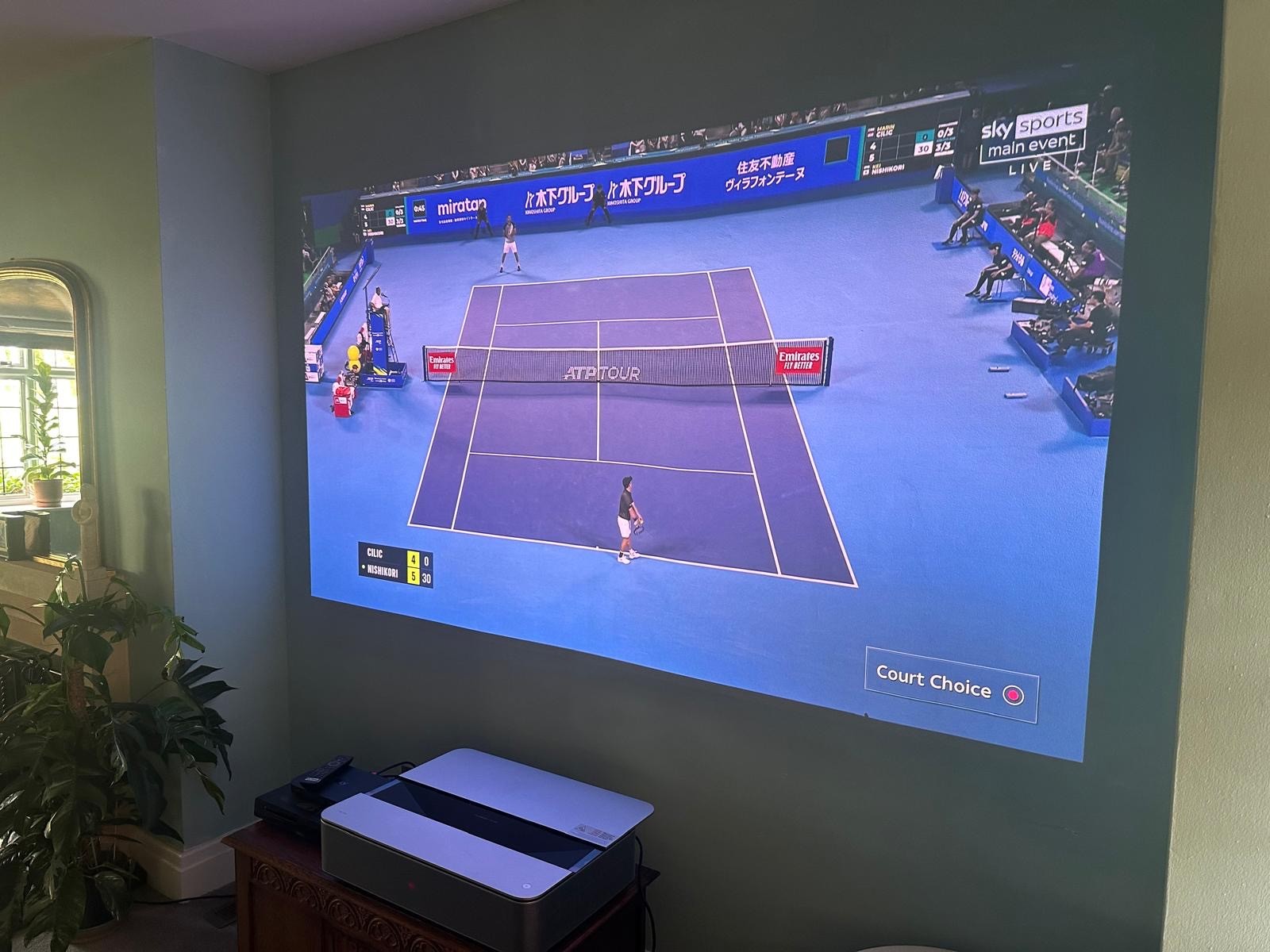 image shows short throw projector and image on wall